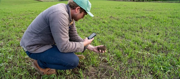 Man looking at soil